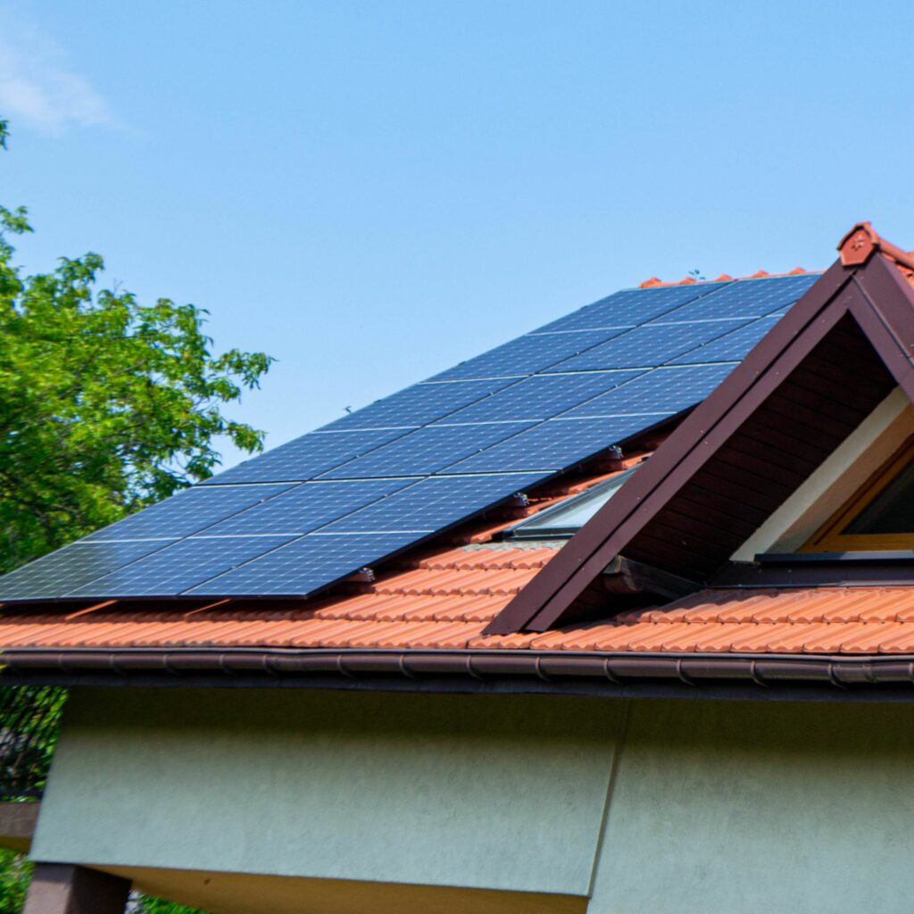 House roof with photovoltaic modules. historic farm house with modern solar panels on roof and wall