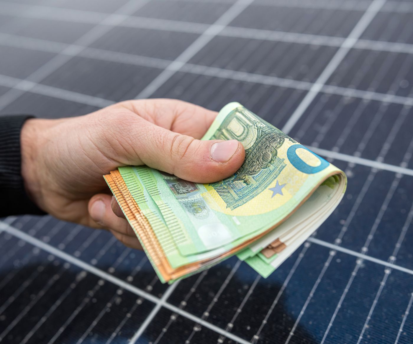 beautiful-young-hands-black-hold-sum-euros-front-solar-panels